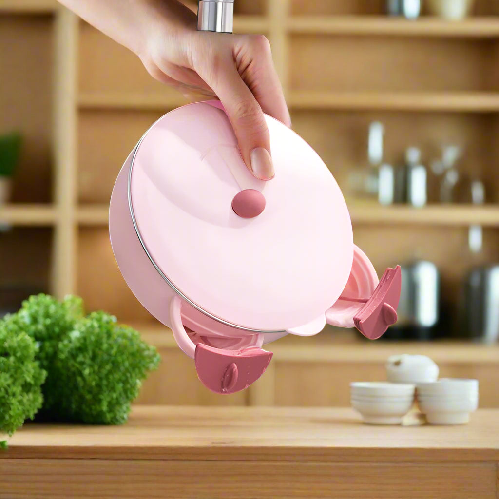 Pink kitchen strainer with water being poured from a faucet into a sink