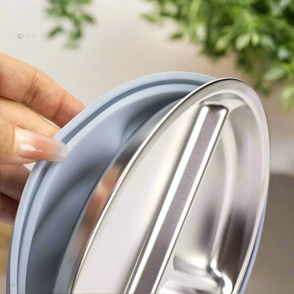 Close-up of a silicone sleeve on a metal container with a hand holding it, highlighting the buckle.
