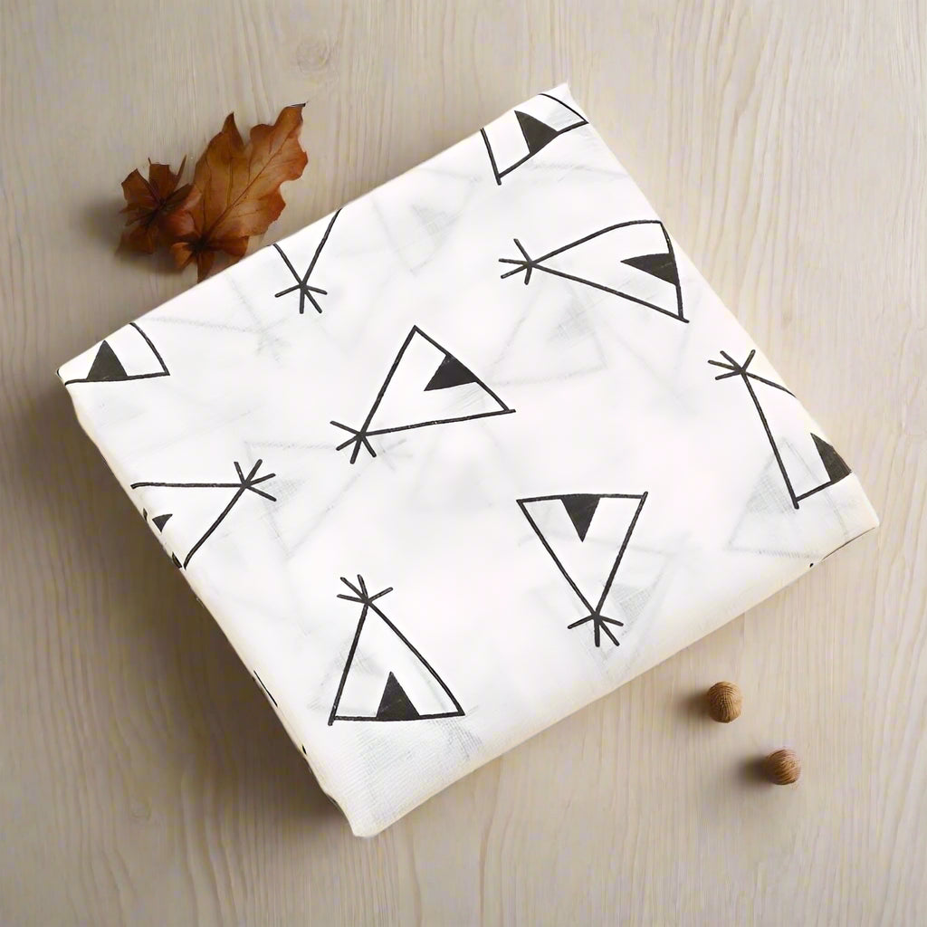 White fabric with black geometric patterns on a beige background
