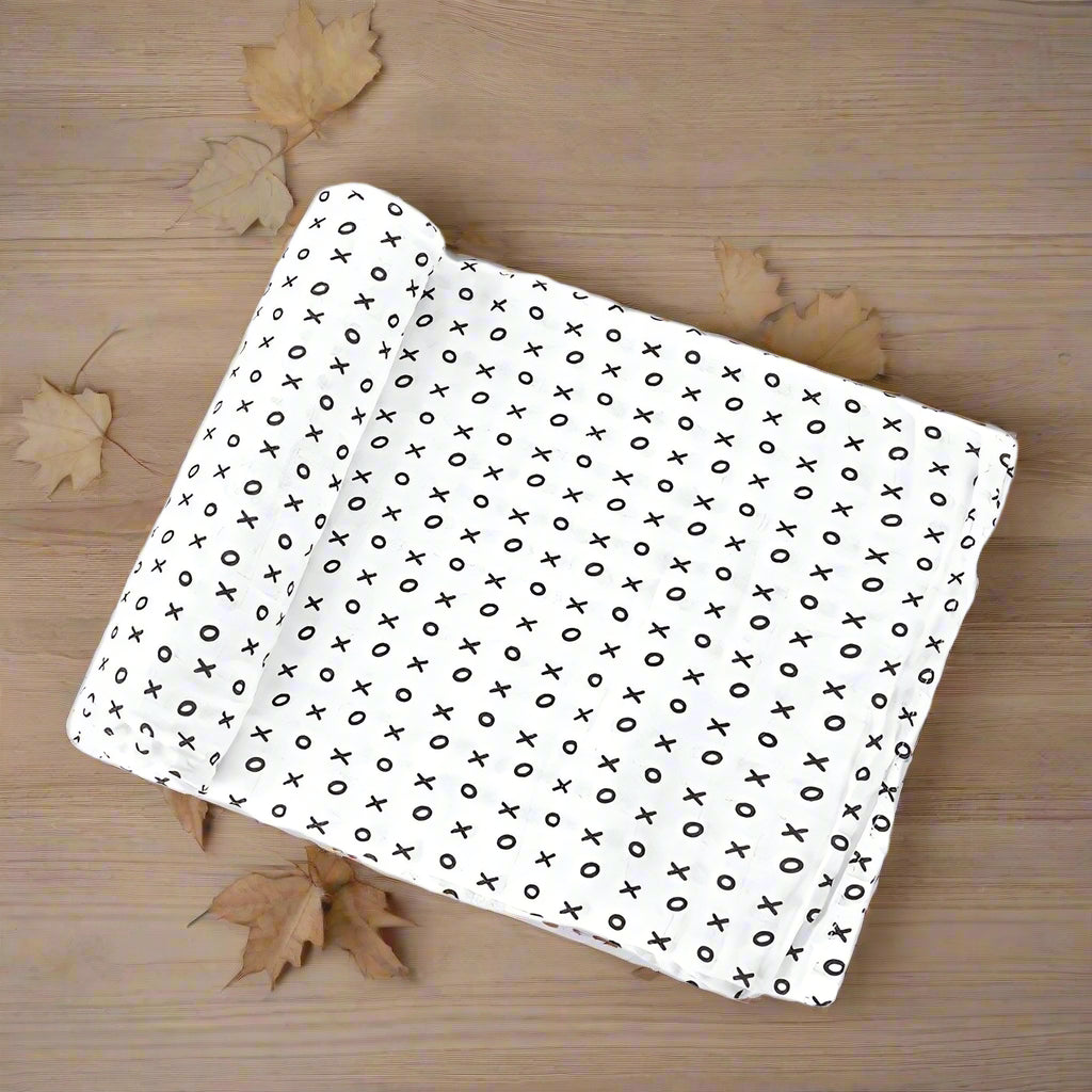 White fabric with black 'X' pattern on a white background
