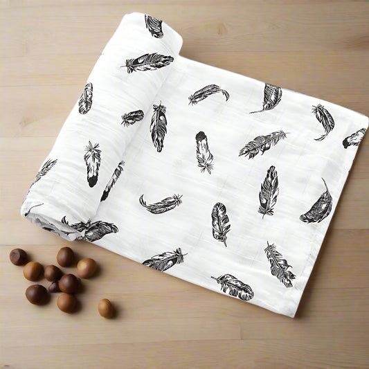 White fabric with black feather pattern and text indicating material composition on a white background