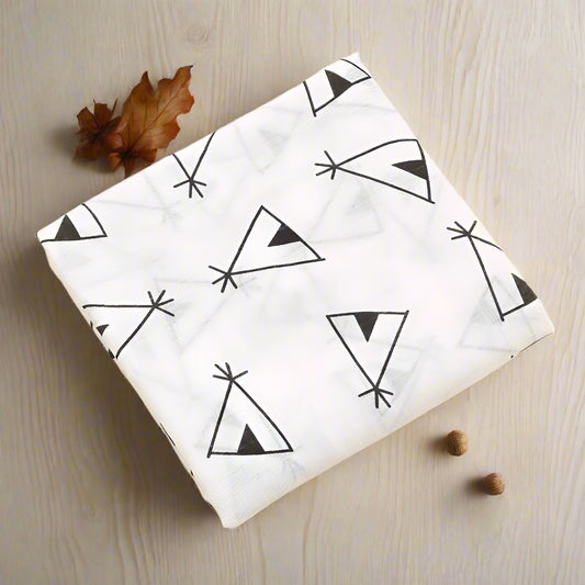 White fabric with black geometric patterns on a beige background