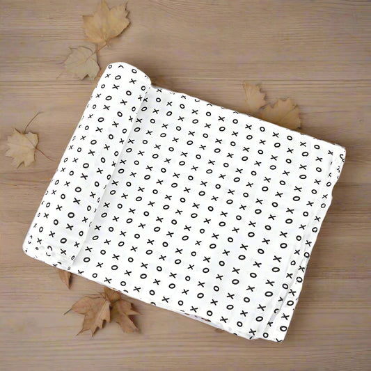 White fabric with black 'X' pattern on a white background